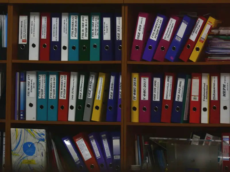 Shelves of labelled ring binders.
